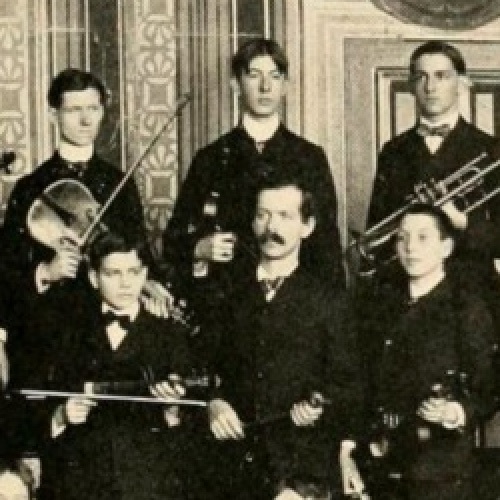 Members of the student orchestra pose with their musical instruments