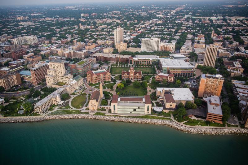 A ariel shot of Loyola's Lake Shore Campus with Lake Michigan bording the bottom. 