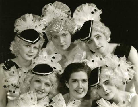 Six Mundelein College students in polka-dotted costumes pose for a photo.