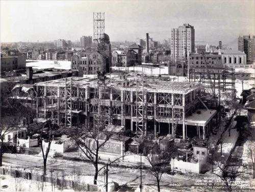 A view of the early construction of the Mundelein College Skyscraper. The framework of the first three floors is visible.