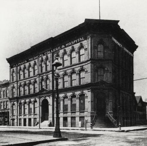 Exterior of the Illinois Medical College and Hospital. A sign on the side of the building reads, "Pharmacy - Dentistry."