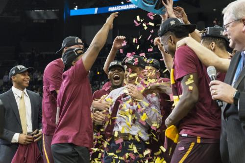 The plays scream with excitement as confetti is dropped on them after their Elite Eight win. 