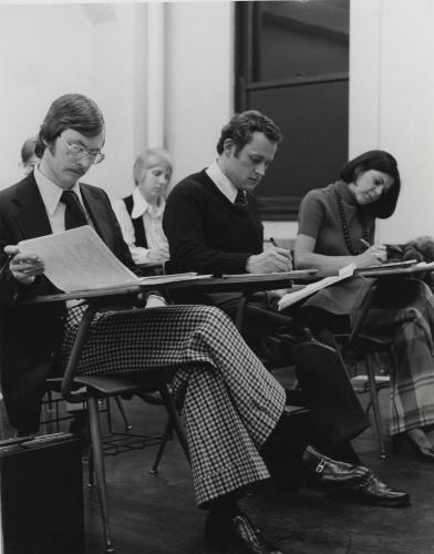 A classroom of five Loyola University Chicago students taking an exam. 